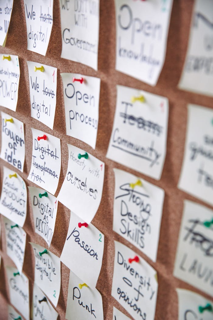 Colorful sticky notes pinned to a cork board for strategic planning and idea collection.